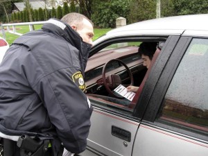 Sgt. Craig Sjolin of the Renton Police Department 'tickets' a Renton High School student for wearing his seat belt Friday morning.