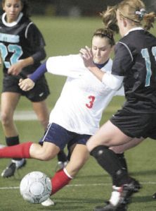 Lindbergh’s Nichole Brunette fights a Bonney Lake player for possession in a Nov. 5 game at Highline Stadium.
