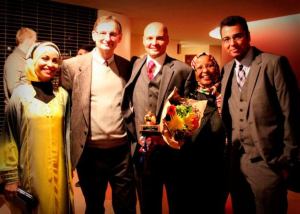 Campbell Hill Principal Zakariya Palsha (middle) celebrates his Golden Apple Award with his wife Nardin Omar (far left); his dad