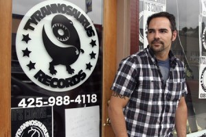 Nich Sullivan stands outside Tyrannosaurus Records