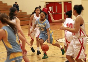 Hazen's Airashay Rogers dribbles through a pack of Renton defenders Jan. 11.