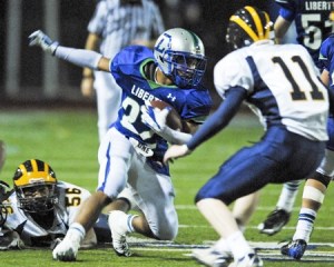 Liberty's Chandler Jenkins runs past Bellevue defenders.