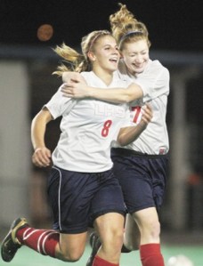 LINDBERGH GIRLS IN A TIE FOR HOMECOMING Lindbergh’s Kaitlyn Osborn congratulates her teammate