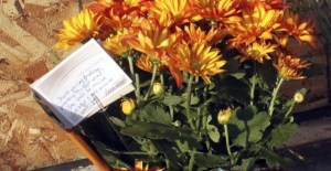 A memorial is growing next to the Farmers Insurance office where office manager Kaye Hall was killed Wednesday when a car crashed through the agency's window.