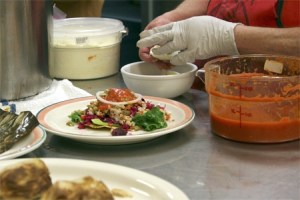 Maria Luisa puts finishing touches to a Guatemalan enchilada
