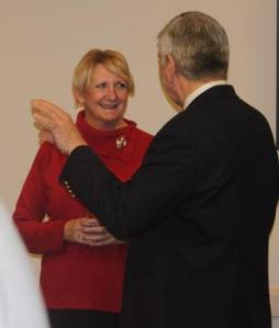 Marcie Palmer shares a joke with a staff member during a reception Dec. 14.