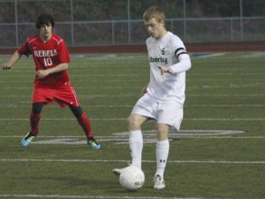 Liberty's Jared Bales moves the ball upfield against Juanita April 3.
