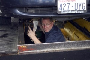 Gary Garvin  works in the well on the air-conditioning unit of one of his customer’s cars recently.