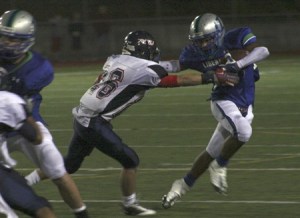 Liberty's Chandler Jenkins fends off a Juanita defender on fourth-quarter rush.