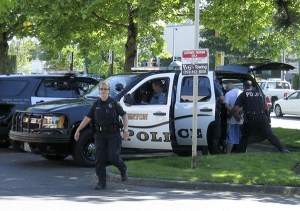 Renton Police officers take into custody a man who fled officers Tuesday afternoon near Lind Avenue South and South 43rd Street after he was stopped while driving a stolen motorcycle.