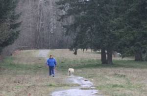 Helen Pacheco and Lucky use one of the informal trails that snakes through the Tiffany Park neighborhood and could be threatened by a housing development.