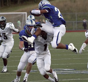 Liberty running back Chandler Jenkins tries to jump over a Skyline defender.