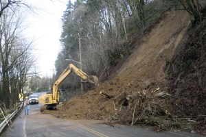 About 500 yards of soil slid down a slide-prone hillside Sunday on the Monster Road in south Renton near its intersection with Martin Luther King Jr. Way. King County crews were out Monday removing the dirt and trees and expect to have the road reopened by Tuesday afternoon. Monster Road is used as a busy commuter bypass around downtown Renton to West Hill.