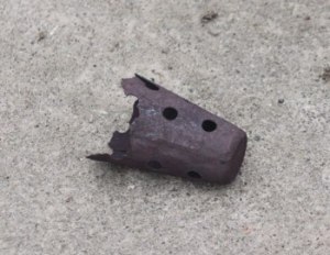 A flame suppressor from a small plane that fell onto the Renton High School baseball field.