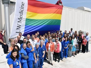 Staff at Valley Medical Center pose with a rainbow flag raised over the hospital in honor of Pride Week.