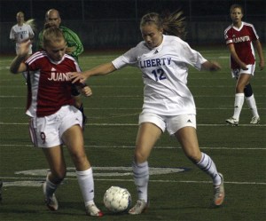 Liberty's Cassidy Nangle moves the ball upfield against Juanita Tuesday night.