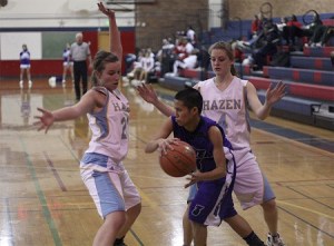 Highlanders Michelle Wnek (right) and Anastasia Pallis hound Foster in a full-court press late in a Feb. 17 tie-breaker game.