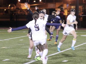 Lindbergh's Lindsey Pfluger celebrates with Elise Aylward (9) after scoring an early goal against Hockinson in the first round of the 2A state tournament Nov. 7.