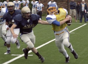 Hazen quarterback Eric Jacobs evades a West Seattle rusher during a June 17 scrimmage.