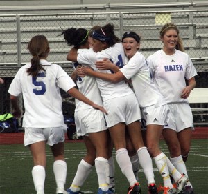 The Hazen soccer team celebrates after a goal.
