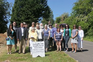 Volunteers pose with Mayor Denis Law during the ceremony.