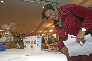 Jean Matthews of Renton Highland Self Storage places her bid on a carpet- cleaning last week during Renton Chamber of Commerce Holiday Auction at the Tea Palace restaurant.