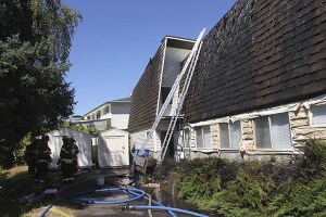 The roof of the Community of Christ Church on Monroe Avenue Northeast was damaged in a fire Tuesday afternoon. Four fire agencies