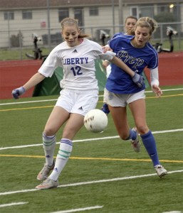 Liberty's Cassidy Nangle takes on a Seattle Prep player in the 3A state title game Nov. 19.