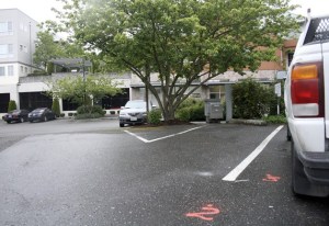 Renton police marked where shell casings were found in the shooting Tuesday night in the Big 5 parking lot that left a 14-year-old Renton boy wounded.