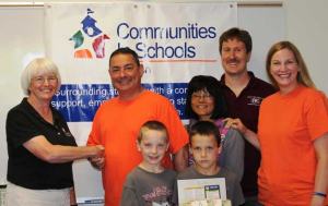 CISR executive director Sue Paronaccepts a check from the 'breakathon' team including Geofrey Driver of Lee’s Martial Arts