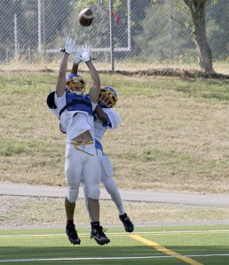 Hazen senior Isaiah Talley (left) jumps for an interception at practice.