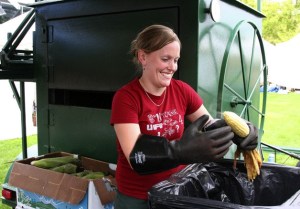 Renton's Karen Bainbridge husks corn at the Renton Farmers Market opening day. A former bank manager she's been selling roasted corn on the cob at the market for about 4 years.