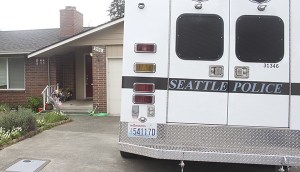 A Seattle Police Department vehicle sits outside Ingrid Lyne's home on Camas Avenue Northeast in Renton Tuesday