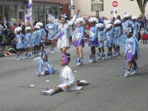 Girls from the Dolls and Gents Drill Team perform their routine during the IKEA Renton River Days parade Saturday. BELOW: Cameron Brown
