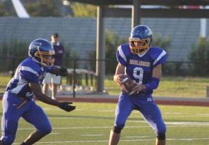 Quarterback Nolan Hoover prepares to hand off the ball.