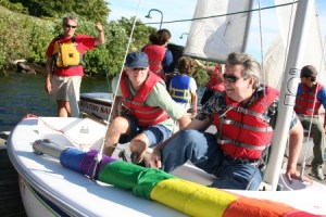 Ross Chamberlain (far left) watches students Ed Buffalow (left) and Roy Slettevold (right) as they practice turning and a jiving on a dock. The Renton Sailing Club offers courses to the public through the City of Renton.