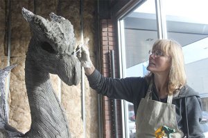 Kim Beaton works on “Brienne” the dragon Tuesday in preparation for this weekend’s first-ever Renton City Comic Convention.
