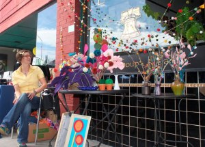 A vendor at last year's Art and Antique walk shows off her wares.