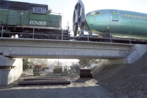 A 737 fuselage rumbles over a closed Shattuck Avenue recently on its way to Boeing’s 737 production plant in north Renton. The road is closed at the railroad bridge in order to install a stormwater control pipeline.