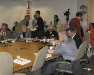 Members of the Board of Commissioners for Public Hospital District No. 1 prepare Monday night for the meeting at which they approved a strategic alliance with UW Medicine. From left are board parliamentarian Robert McBeth and commissioners Sue Bowman