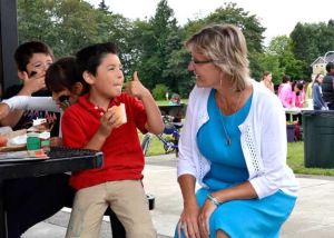 Renton School District Superintendent Merri Rieger interacts with a boy at Heritage Park July 10.