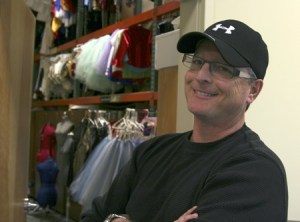 Evergreen City Ballet's artist director Kevin Kaiser stands in front of the costume storage room of the ballet's new building on Lind Avenue Southwest. The space is smaller than their former location in downtown Renton