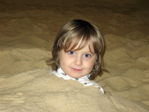 Patrick Ossorio sticks his head out of the sand at The Sandbox in the Georgetown neighborhood of Seattle.