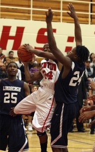 Renton's D.J. Eubanks goes up for a shot while Lindbergh's Derek Roseboro defends.