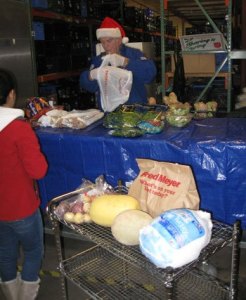 A Salvation Army volunteer helps a guest in need with supplies for Thanksgiving. About 500 people are expecting food baskets from the center.