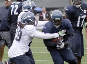 Seattle's Marshawn Lynch rushes through defenders at practice.