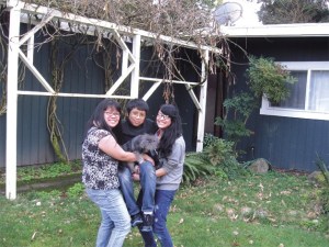 Sally de Leon and her children Mark and Bernadette Sheran have some fun outside their new home in Bellevue.