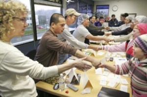 Employees at Orca Bay Seafood  in Renton practice the English used in introducing one’s self in an ESL class taught by Elizabeth Falconer