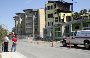 Renton fire investigators determined Thursday that the fire that gutted one of the two main buildings of Harrington Square Apartments was started by roofing crews. The second building was untouched by the flames. One of the building's developers