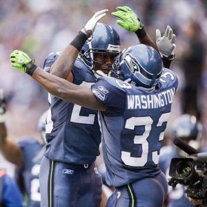 Seattle's Leon Washington celebrates after one of his two kickoff returns for a touchdown Sunday against the Chargers.